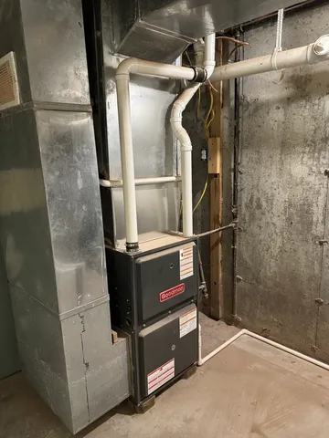 a room with water heater and wooden racks