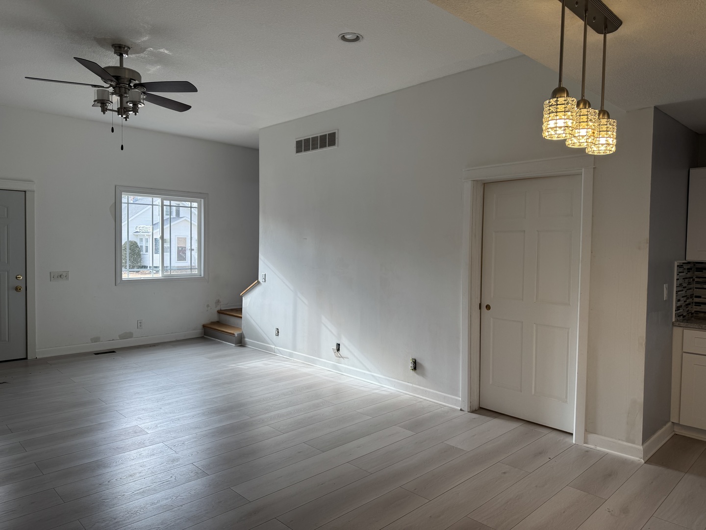 612 15th Avenue Sterling, IL 61081 - Photo 6 of 33 a view of an empty room with a window and wooden floor