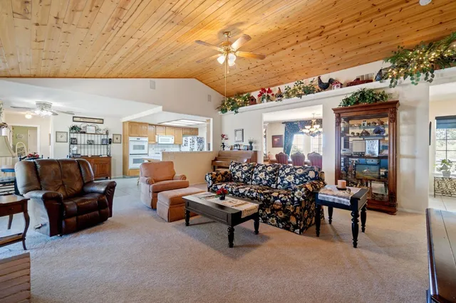 a living room with furniture and flowers