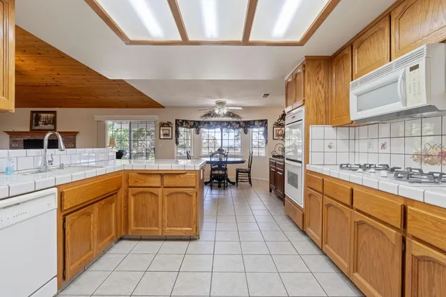 a kitchen with stainless steel appliances granite countertop a sink and cabinets