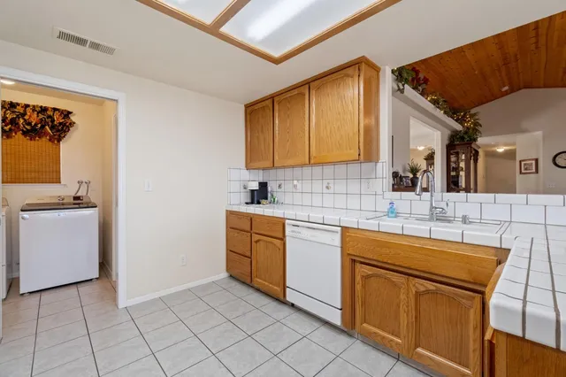 a kitchen with a sink cabinets and appliances
