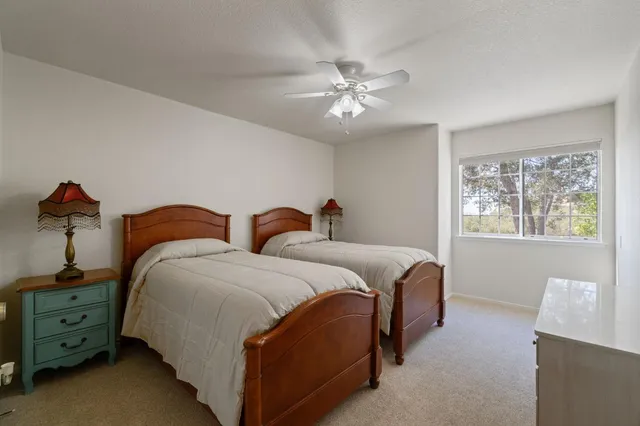 a spacious bedroom with two beds and painted walls