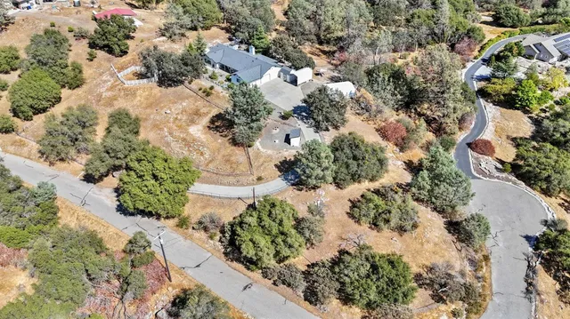 an aerial view of residential house with yard