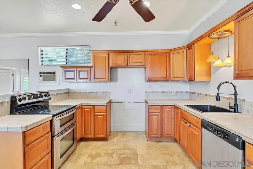 23611-13 Old Ranch Road Alpine, CA 91901 - Photo 9 of 25 a kitchen with stainless steel appliances granite countertop a sink and a stove