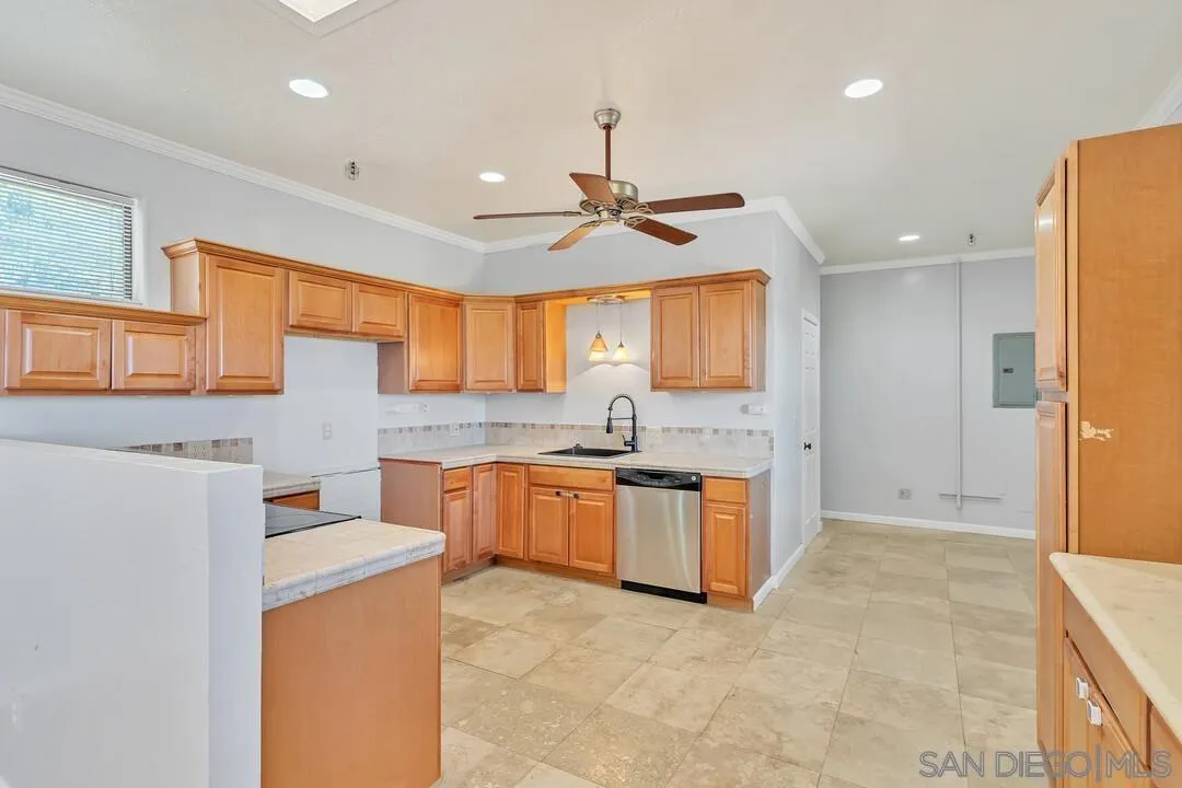23611-13 Old Ranch Road Alpine, CA 91901 - Photo 10 of 25 a kitchen with stainless steel appliances granite countertop a refrigerator a sink dishwasher a stove and white countertops with wooden floor