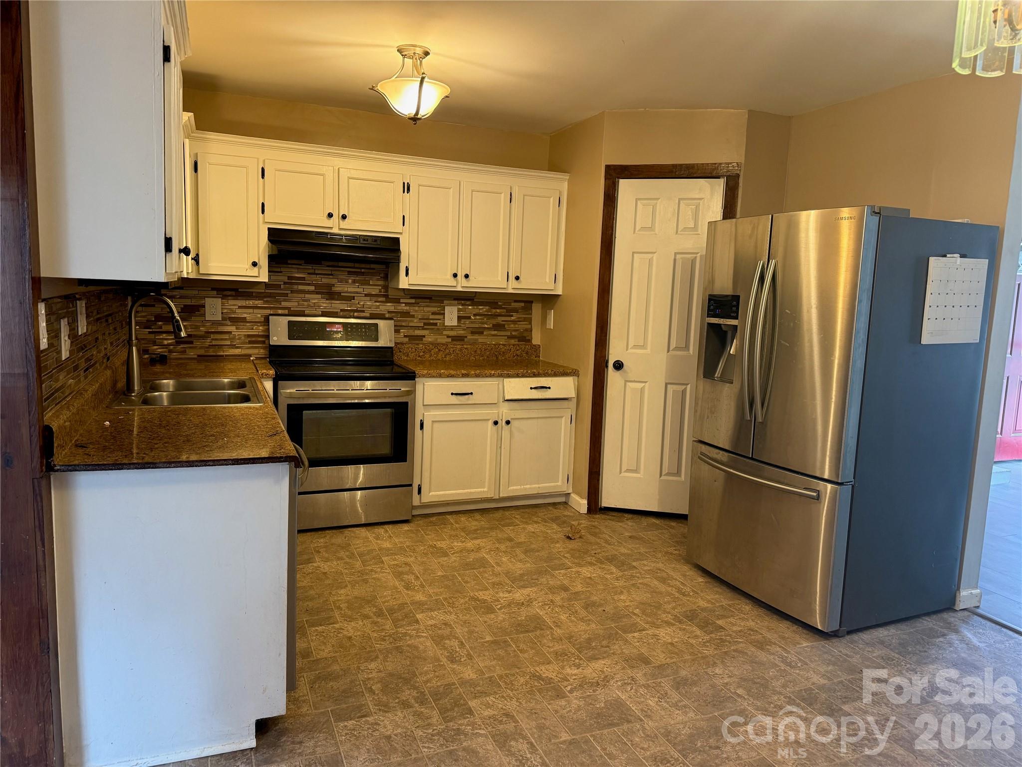 309 Mel Lane Crouse, NC 28033 - Photo 11 of 35 a kitchen with stainless steel appliances a refrigerator sink and microwave