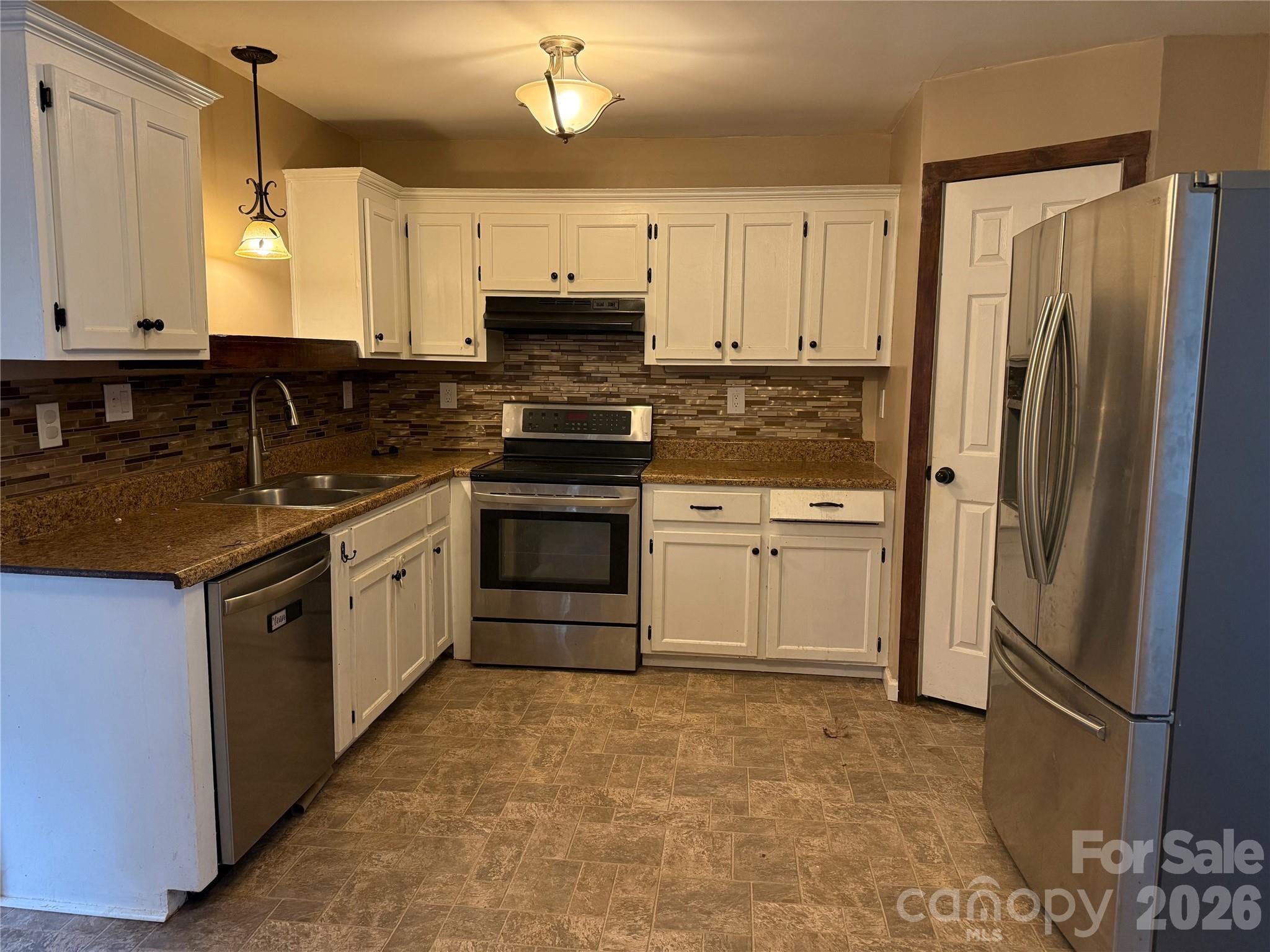 309 Mel Lane Crouse, NC 28033 - Photo 12 of 35 a kitchen with stainless steel appliances granite countertop a stove a sink and a refrigerator