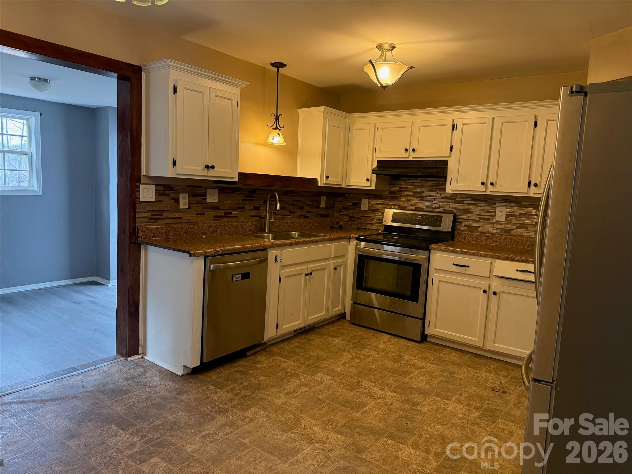 309 Mel Lane Crouse, NC 28033 - Photo 13 of 35 a kitchen with stainless steel appliances granite countertop a stove a sink and a refrigerator