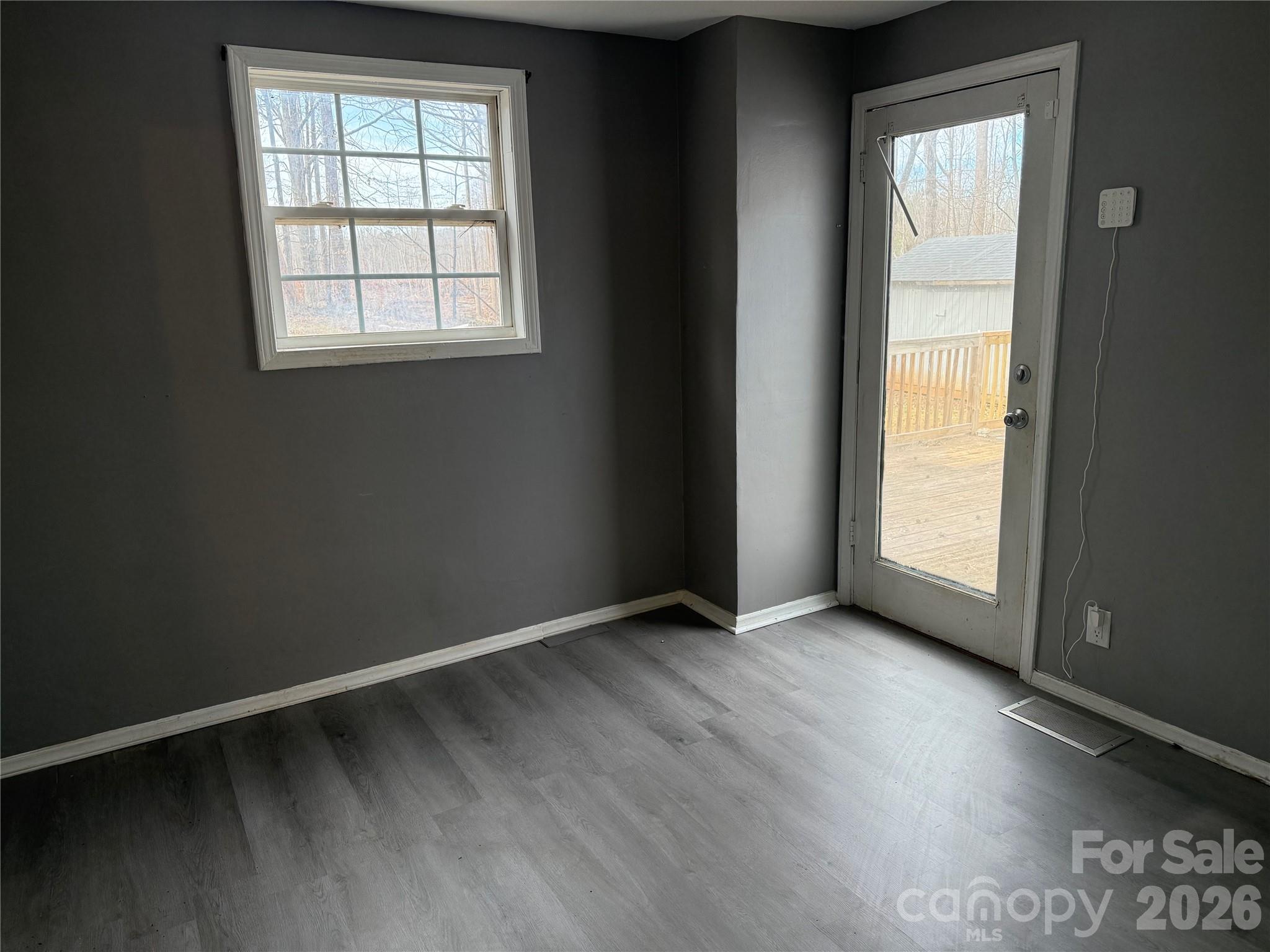 309 Mel Lane Crouse, NC 28033 - Photo 16 of 35 an empty room with wooden floor and windows