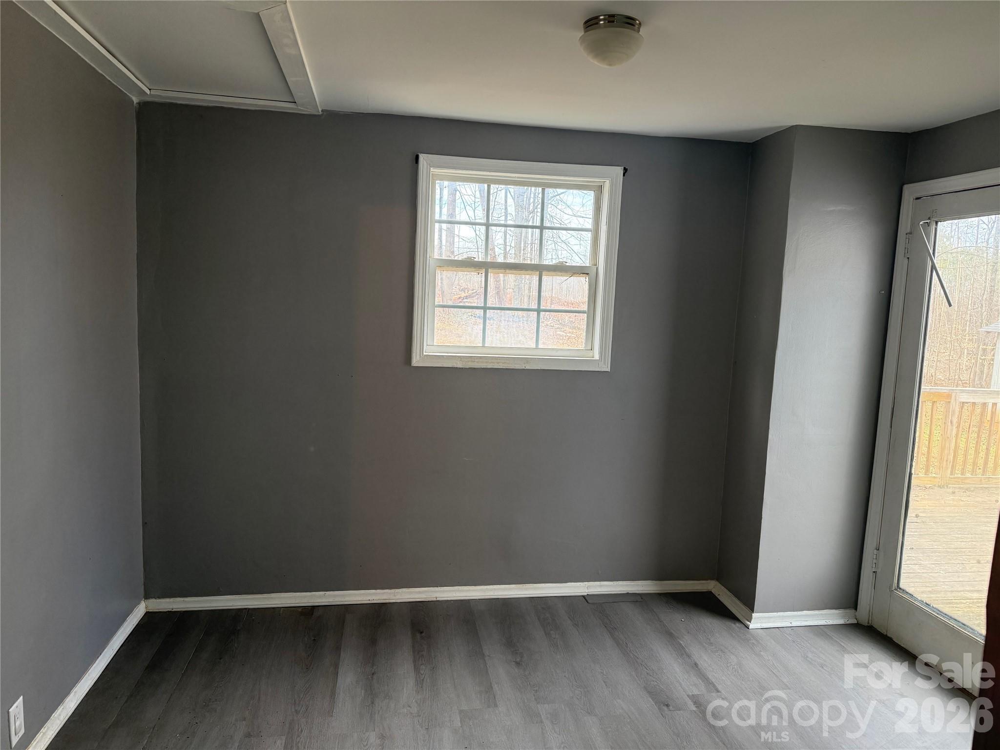 309 Mel Lane Crouse, NC 28033 - Photo 17 of 35 an empty room with wooden floor and windows