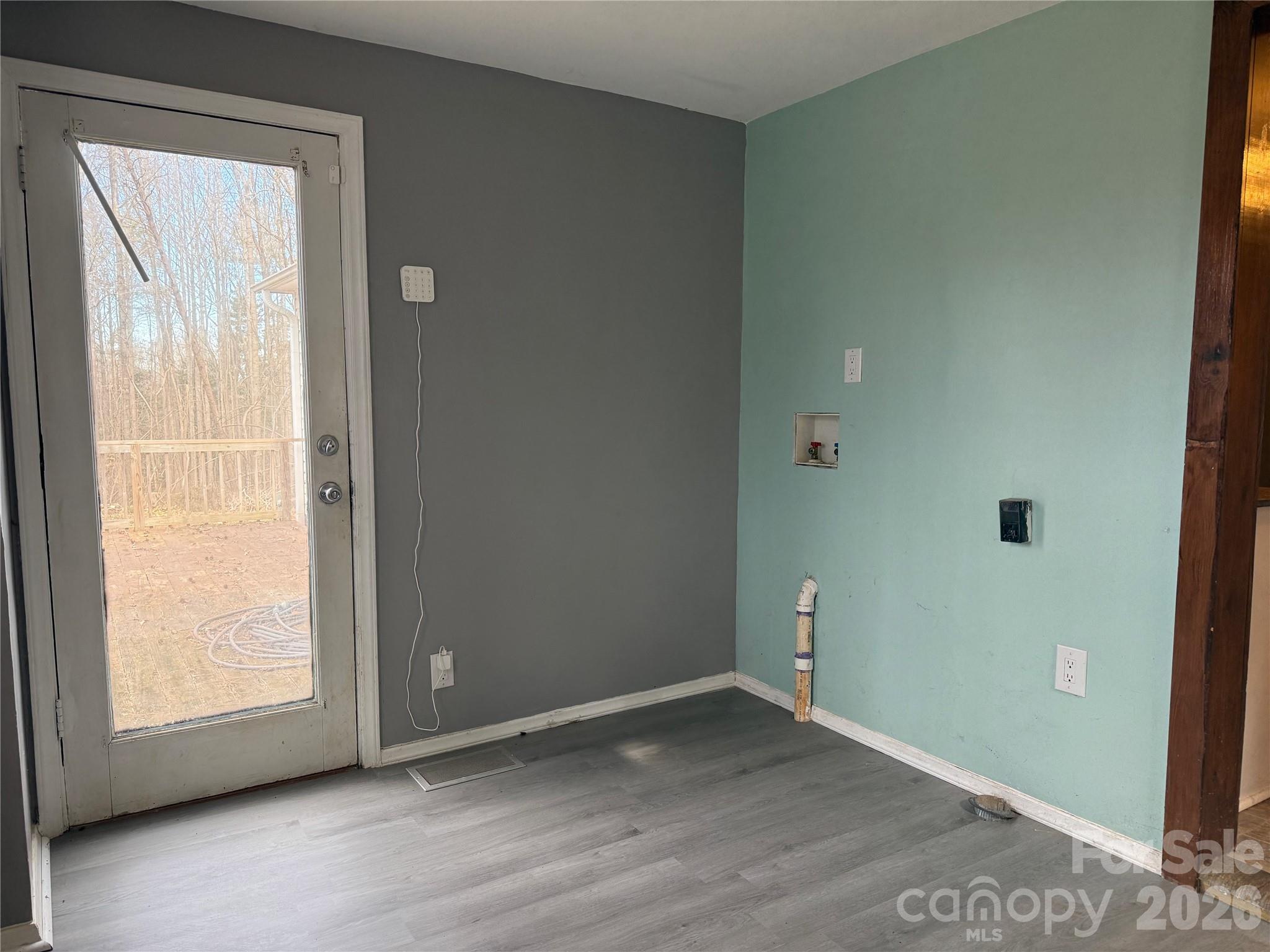 309 Mel Lane Crouse, NC 28033 - Photo 18 of 35 an empty room with wooden floor and windows