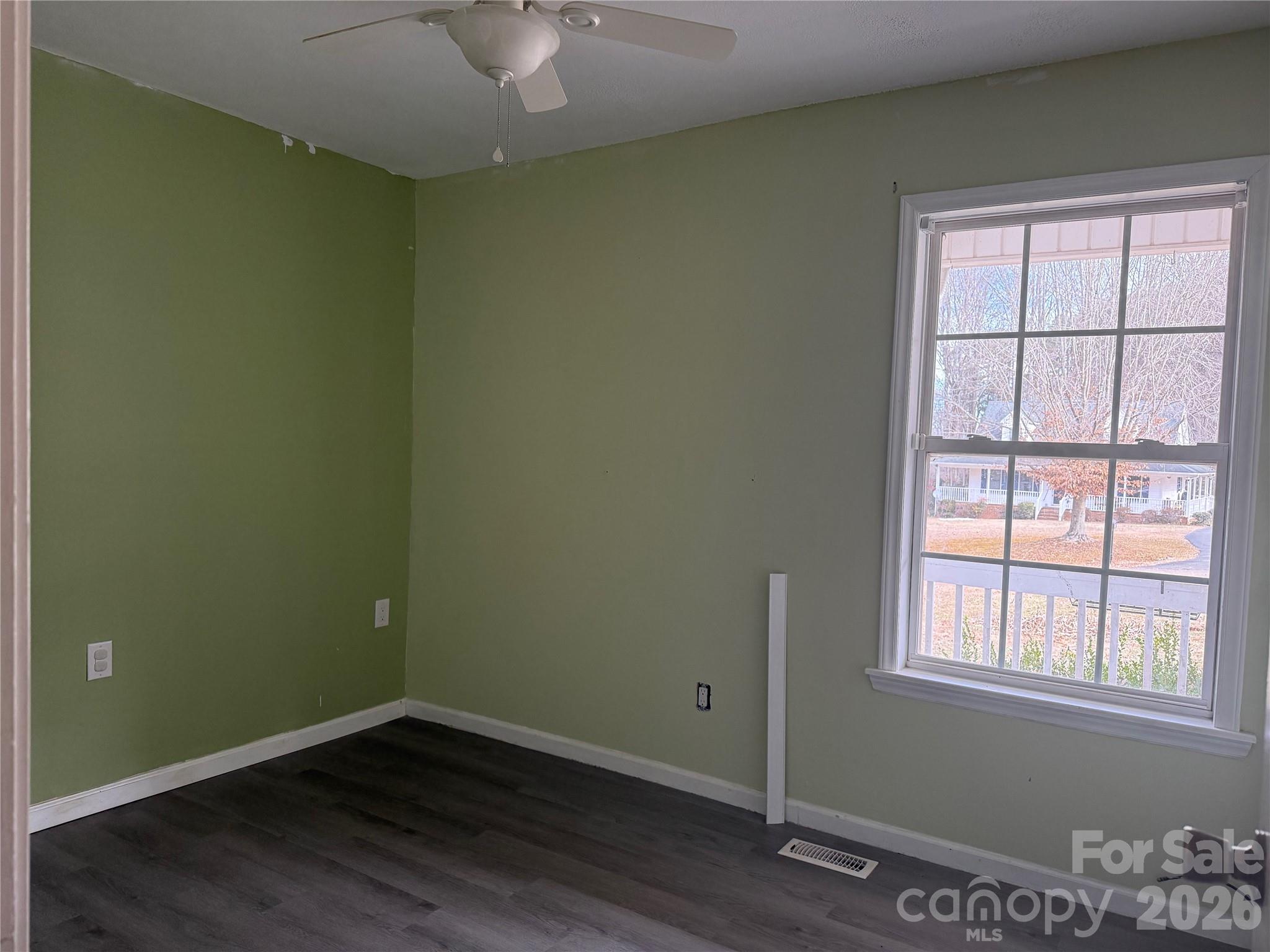 309 Mel Lane Crouse, NC 28033 - Photo 24 of 35 an empty room with wooden floor and windows