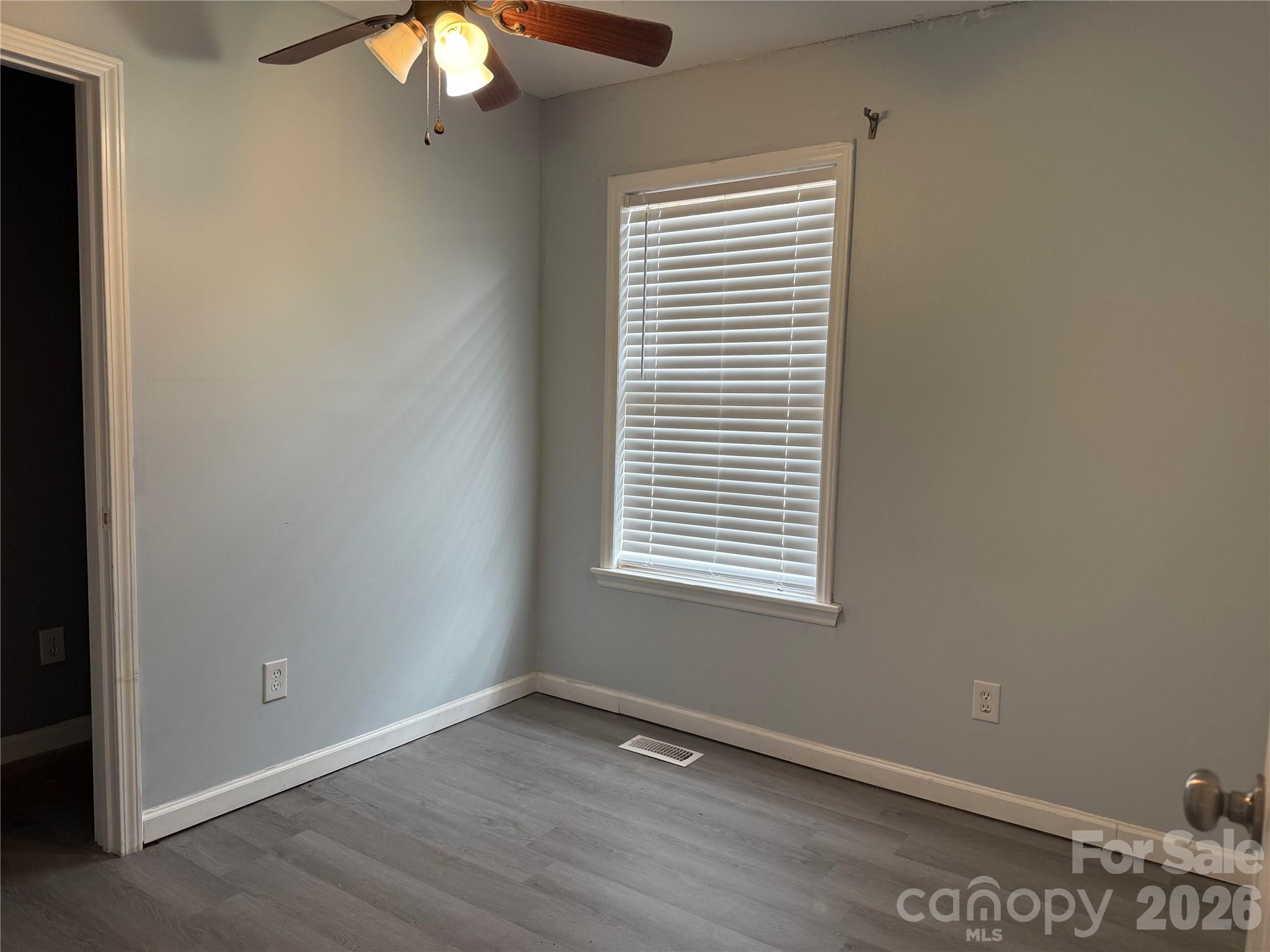 309 Mel Lane Crouse, NC 28033 - Photo 25 of 35 a view of an empty room with wooden floor and a window