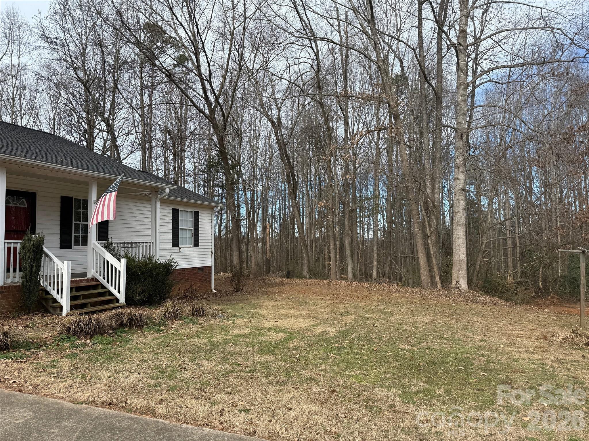 309 Mel Lane Crouse, NC 28033 - Photo 3 of 35 a house with trees in front of it