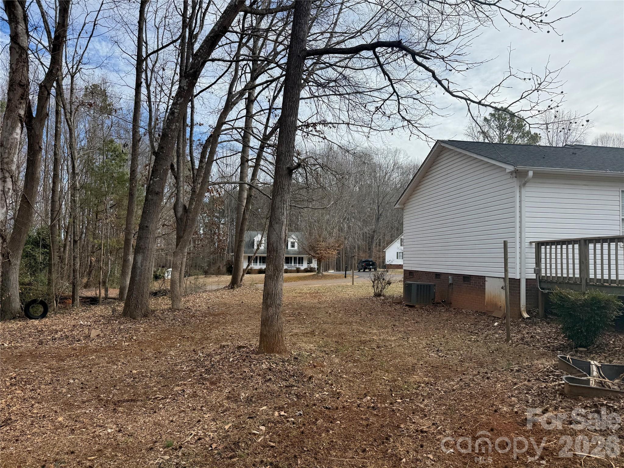 309 Mel Lane Crouse, NC 28033 - Photo 34 of 35 a view of a yard with a house and a tree