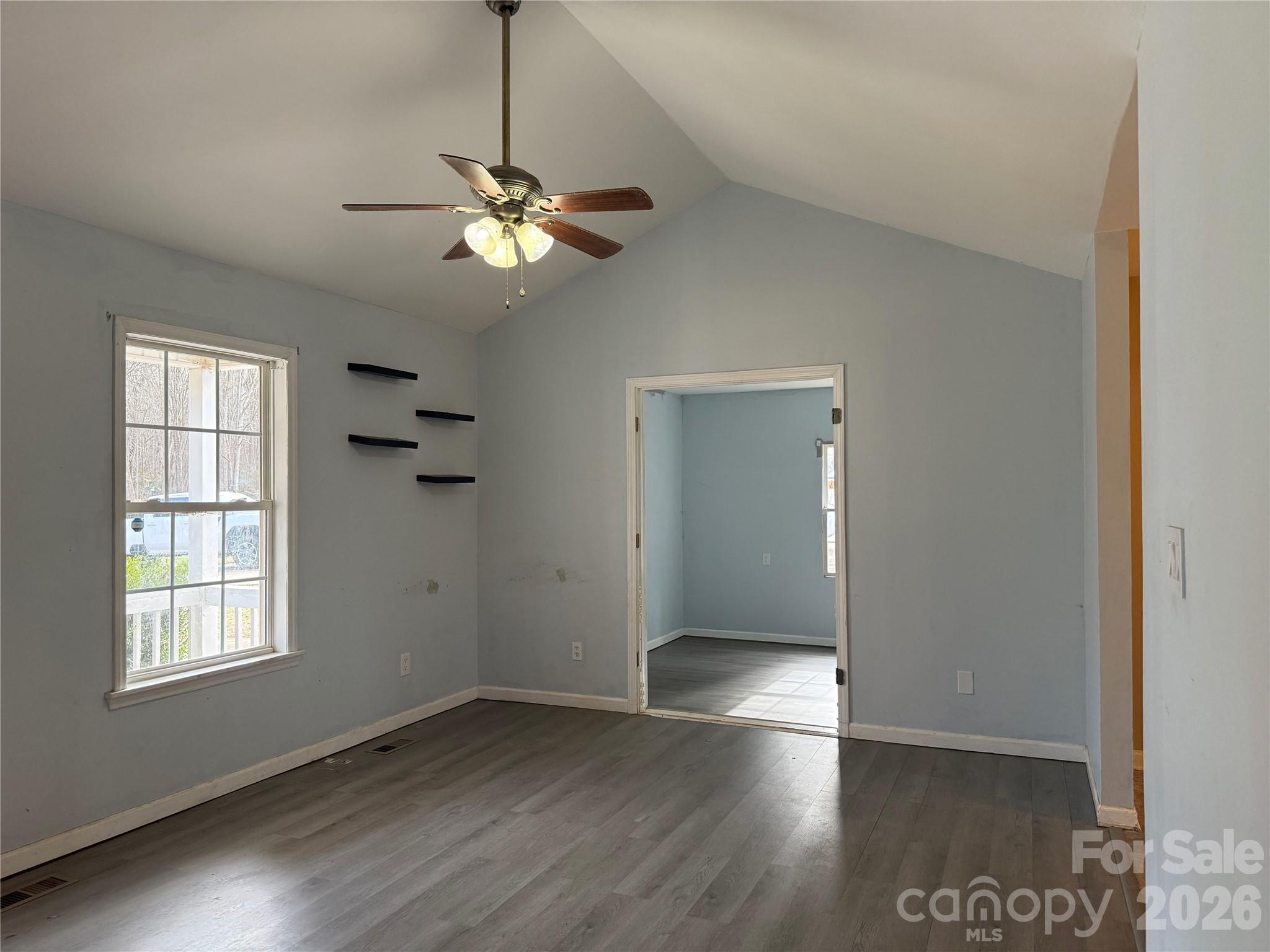 309 Mel Lane Crouse, NC 28033 - Photo 6 of 35 a view of empty room with wooden floor and fan