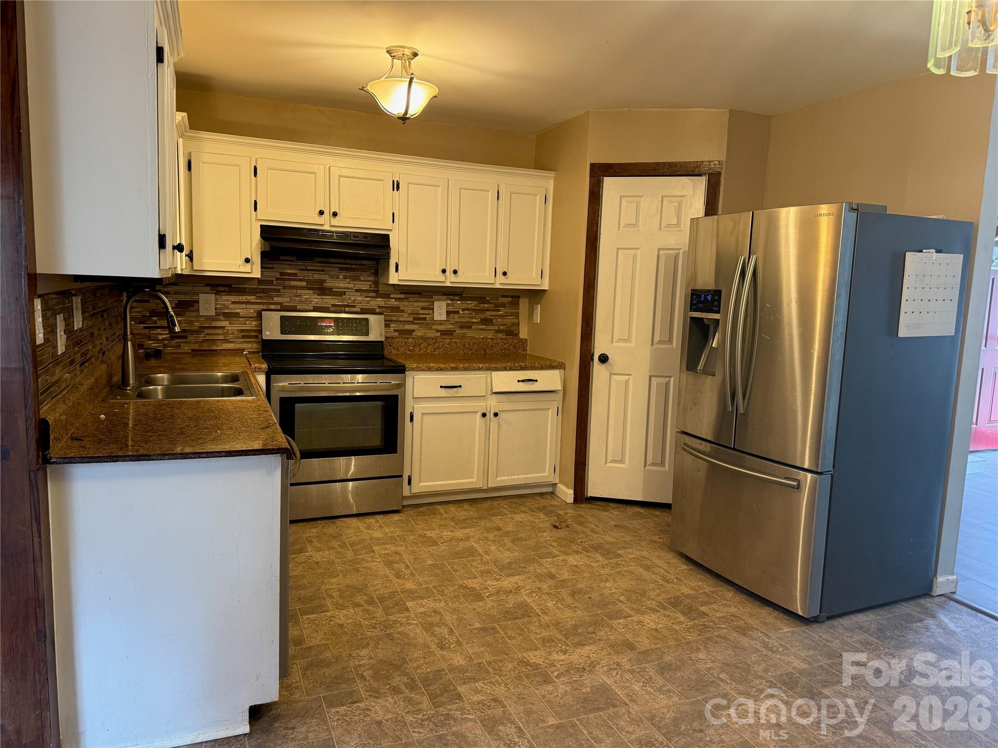 309 Mel Lane Crouse, NC 28033 - Photo 10 of 35 a kitchen with stainless steel appliances a refrigerator stove and microwave