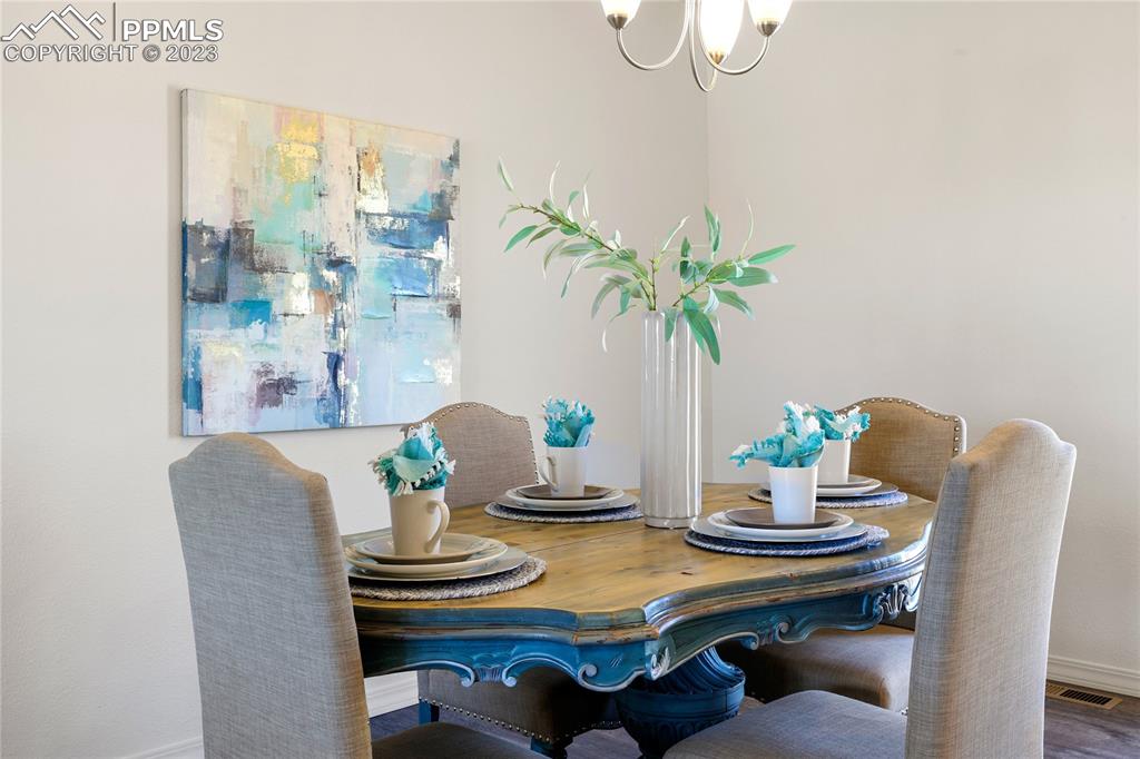 208 High Meadows Drive Florence, CO 81226 - Photo 11 of 32 a dining room with furniture and potted plants