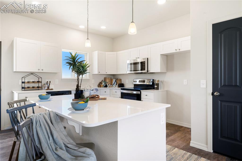 208 High Meadows Drive Florence, CO 81226 - Photo 16 of 32 a kitchen with a sink a stove and chairs
