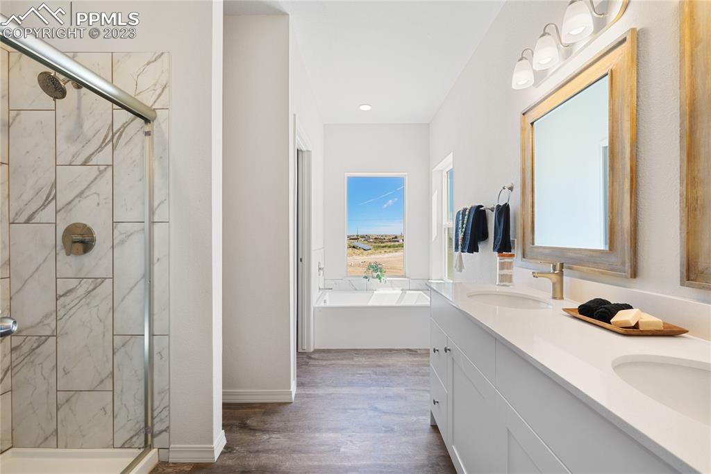 208 High Meadows Drive Florence, CO 81226 - Photo 22 of 32 a bathroom with a double vanity sink and mirror