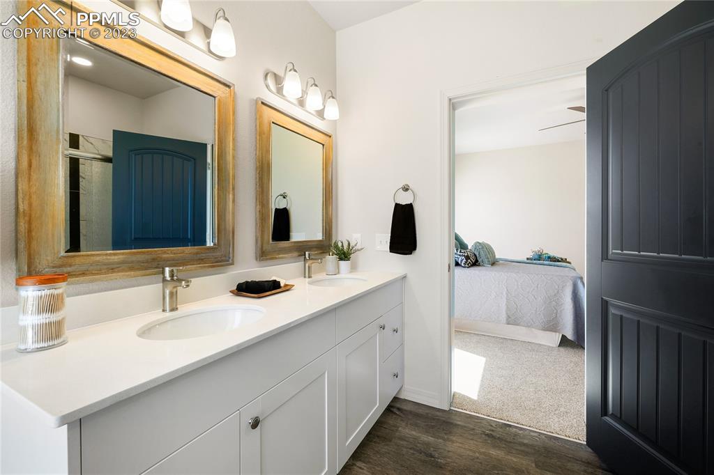 208 High Meadows Drive Florence, CO 81226 - Photo 23 of 32 a en suite bathroom with a double vanity sink and mirror
