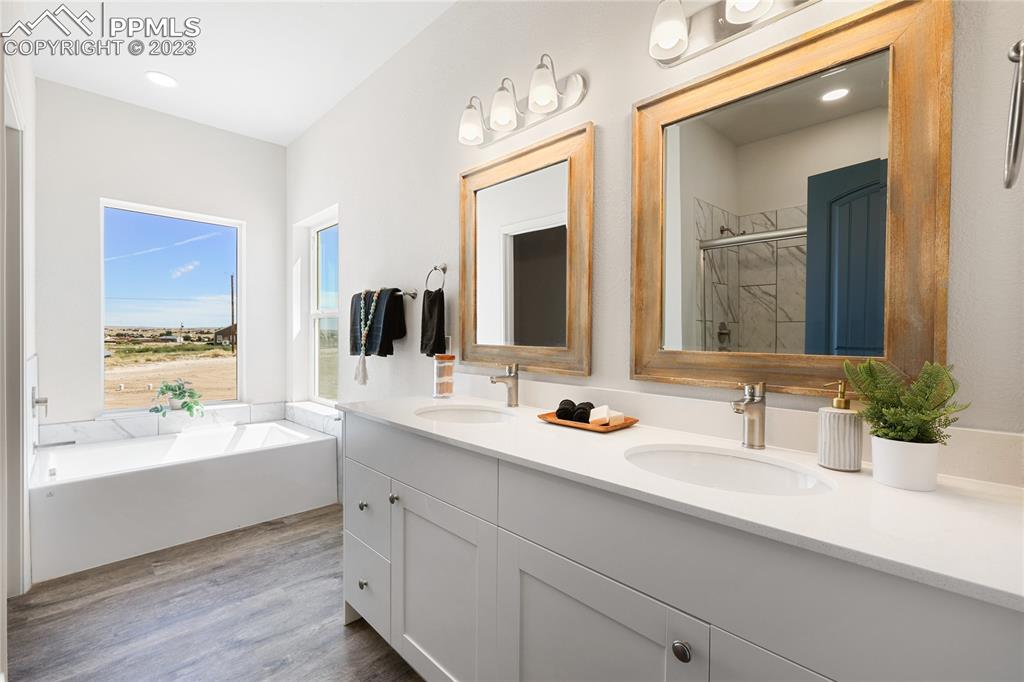 208 High Meadows Drive Florence, CO 81226 - Photo 24 of 32 a bathroom with a double vanity sink mirror double and bathtub