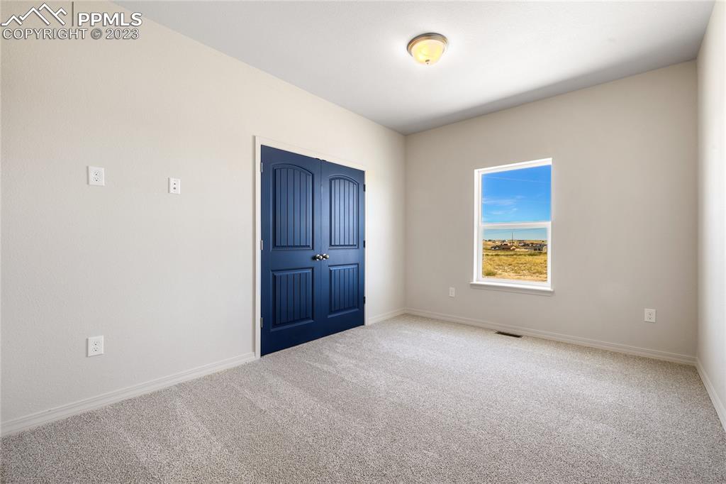 208 High Meadows Drive Florence, CO 81226 - Photo 27 of 32 an empty room with windows and closet
