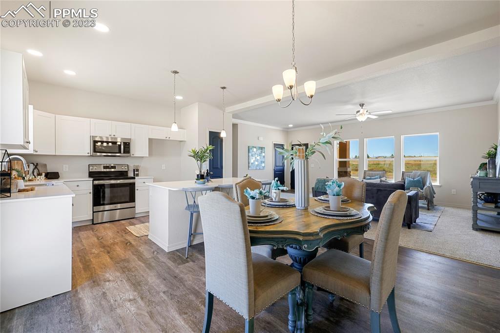 208 High Meadows Drive Florence, CO 81226 - Photo 8 of 32 a view of a dining room with furniture a kitchen and chandelier