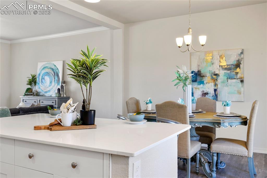 208 High Meadows Drive Florence, CO 81226 - Photo 10 of 32 a dining room with furniture and chandelier