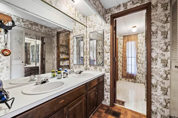 a bathroom with a double vanity sink and mirror
