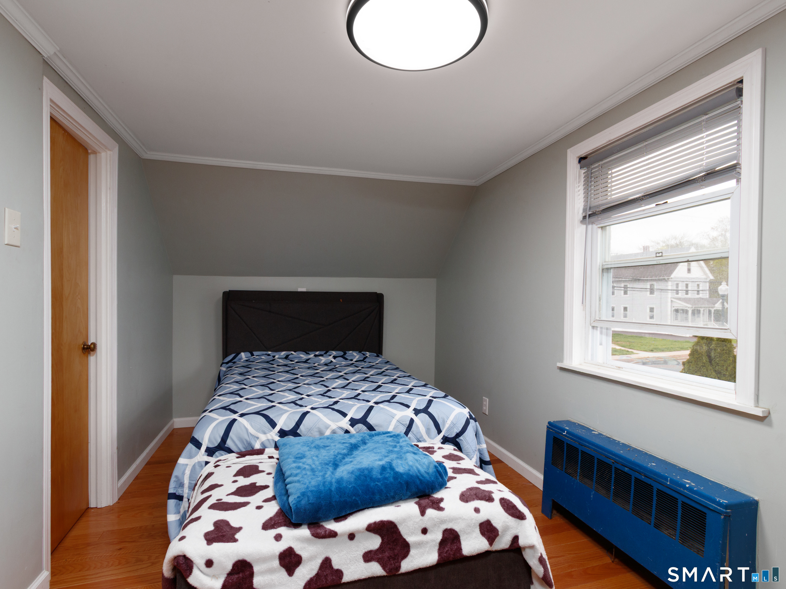 236 Hall Avenue Wallingford, CT 06492 - Photo 34 of 40 a bedroom with a bed and wooden floor