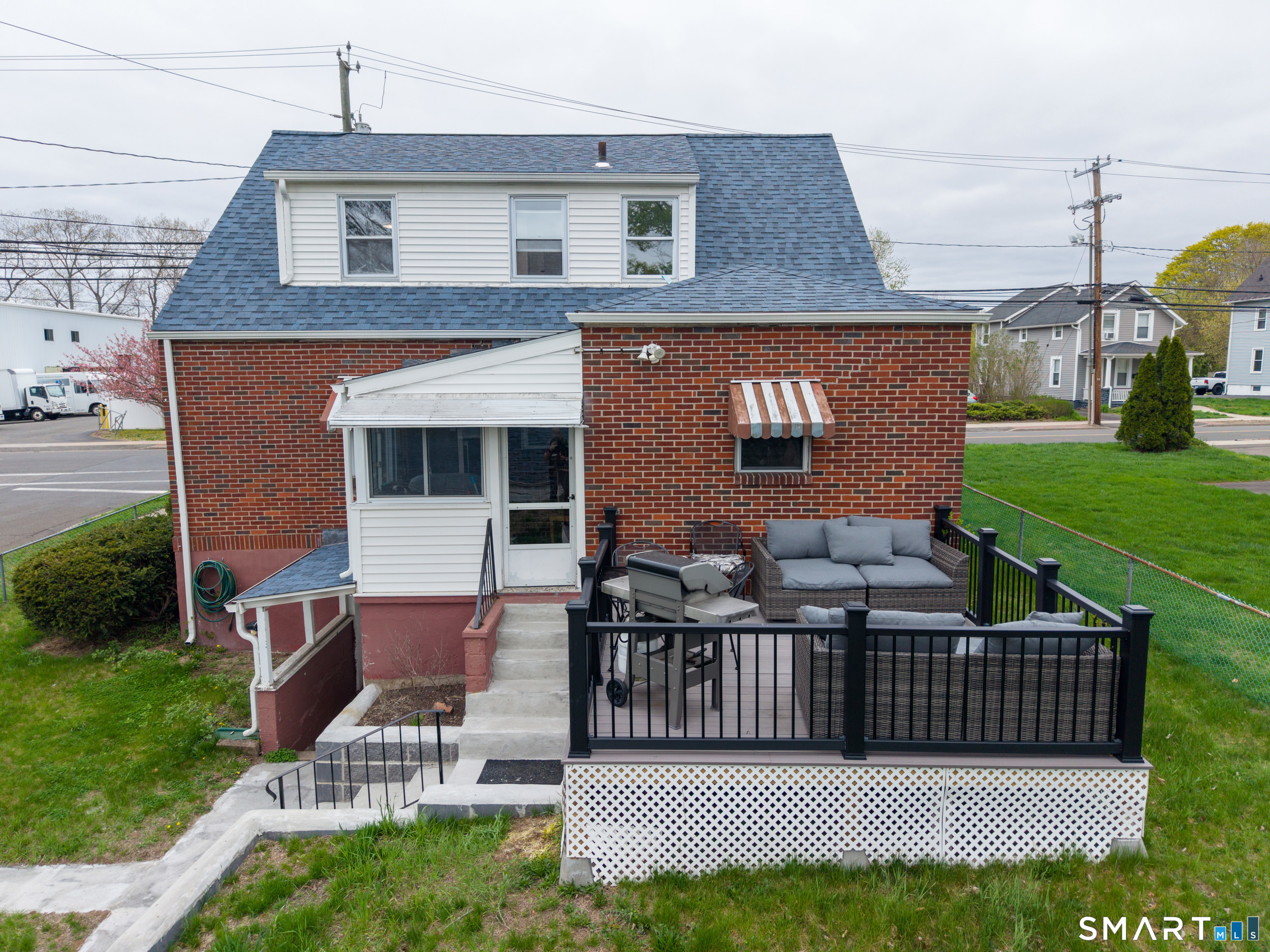 236 Hall Avenue Wallingford, CT 06492 - Photo 6 of 40 a view of a house with a small yard and a wooden deck