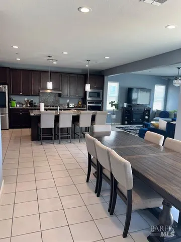 a large kitchen with lots of counter space and furniture