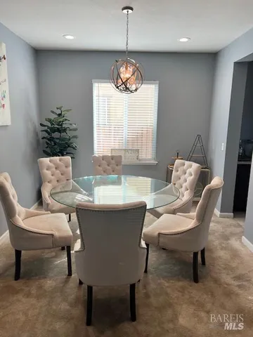 a dining room with furniture and window