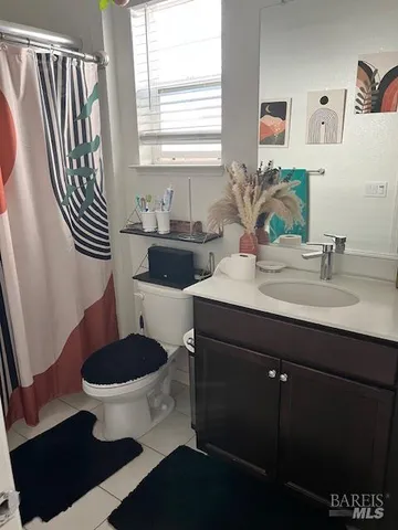 a bathroom with a sink toilet and mirror