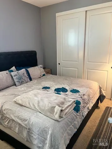 a bedroom with a bed and a walk in closet