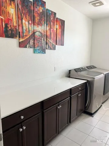 a utility room with a sink and cabinets