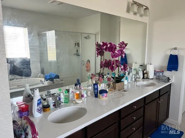 a bathroom with a sink double vanity and a mirror