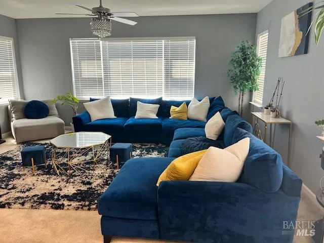 a living room with furniture and floor to ceiling windows