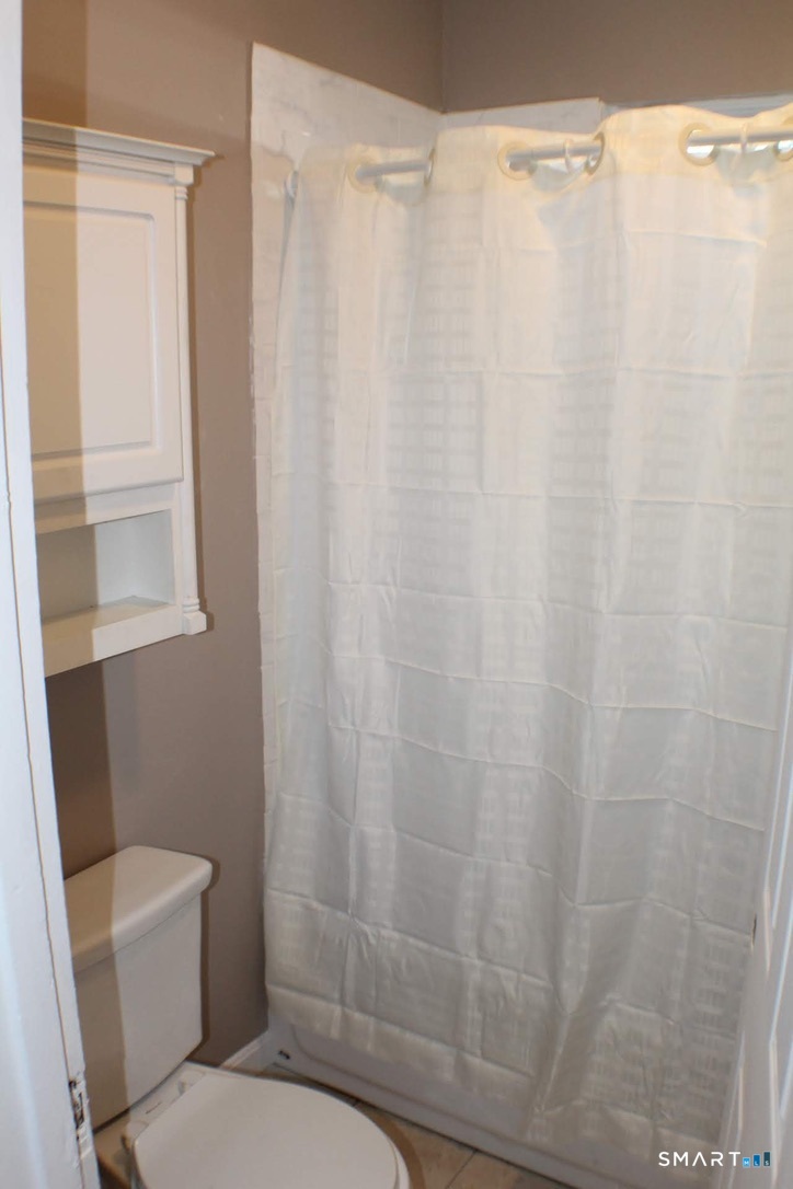 150 Whitney Street Hartford, CT 06105 - Photo 5 of 39 a bathroom with a shower curtain and sink