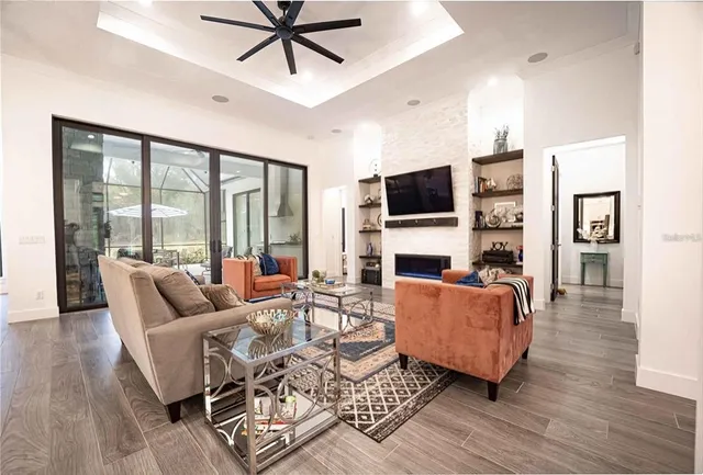 a living room with furniture a fireplace and a flat screen tv