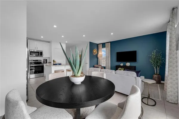 a living room with dining room and a table