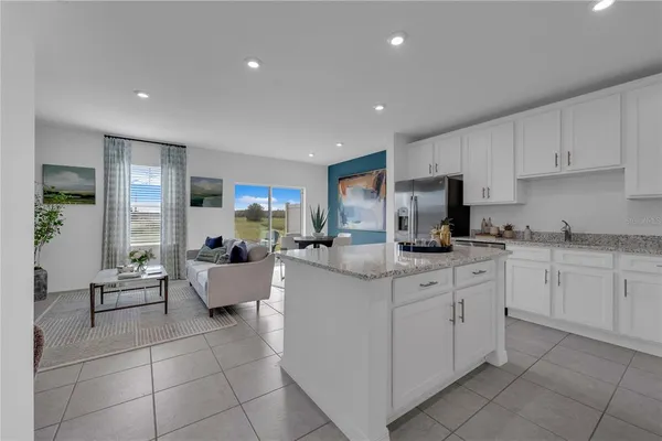 a kitchen with cabinets and chairs
