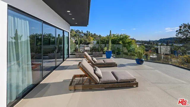 a view of a patio with a table and chairs