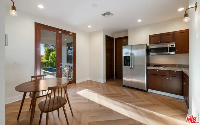 a kitchen with stainless steel appliances granite countertop a refrigerator and a stove top oven