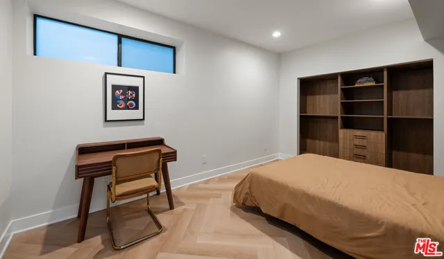 a bedroom with a bed and a chair