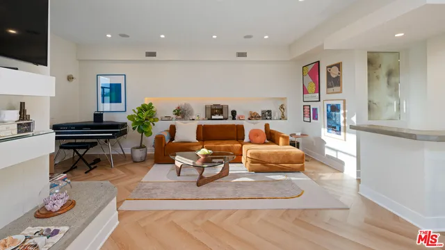 a living room with furniture and a piano