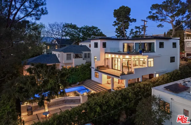 a front view of a house with yard and green space