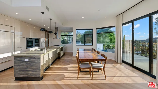 a room with lots of wooden furniture and a large window