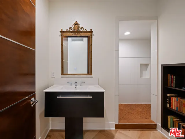 a bathroom with a sink a toilet and a mirror